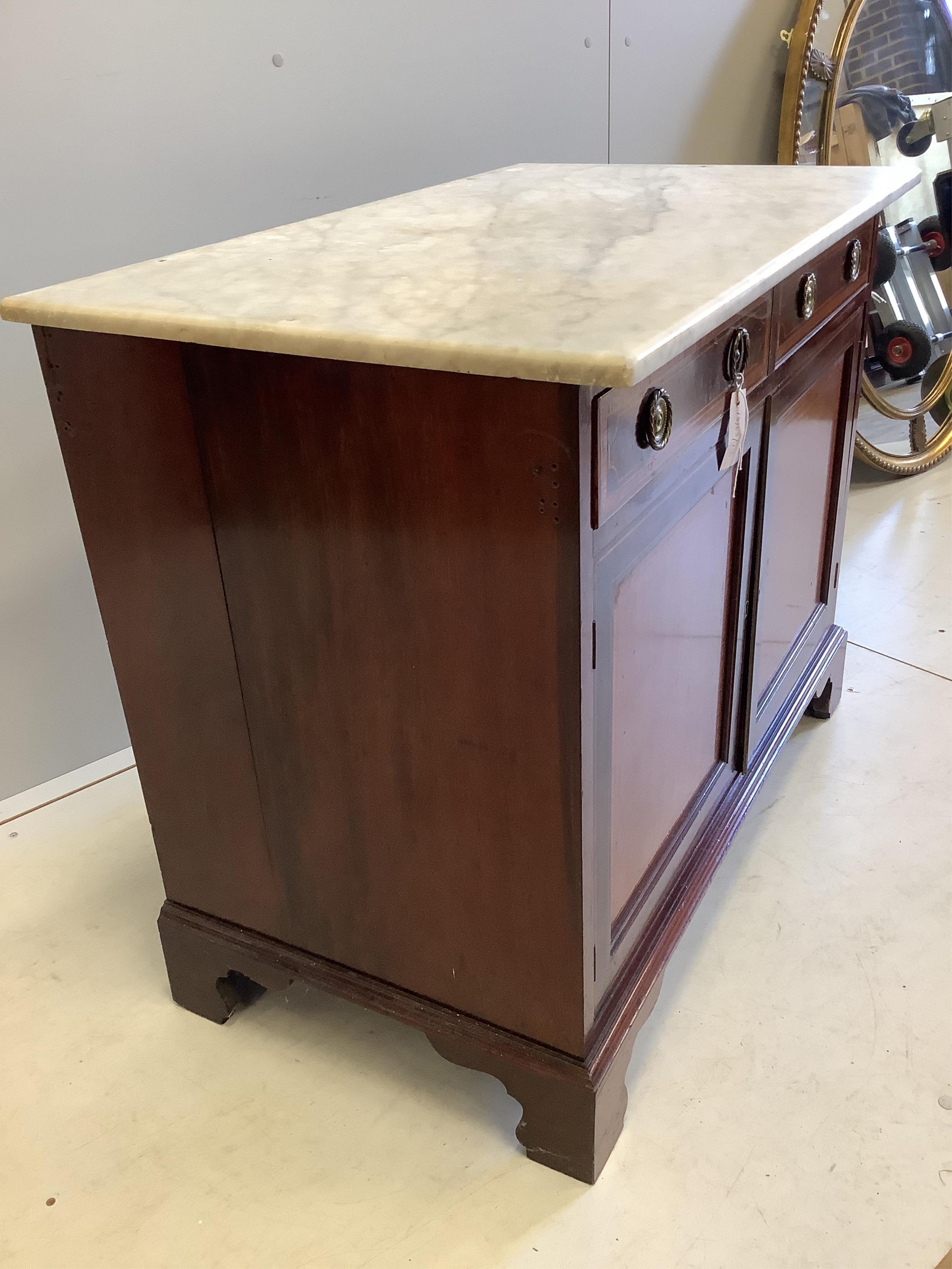 An Edwardian satinwood banded and inlaid mahogany two door side cabinet, fitted two frieze drawers and a white marble top on bracket feet, width 92cm, depth 54cm, height 75cm